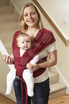 Royalty Free Photo of a Baby in a Sling With Her Mother