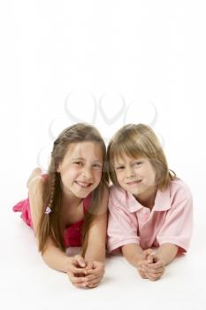 Two Children Laying on Stomach in Studio