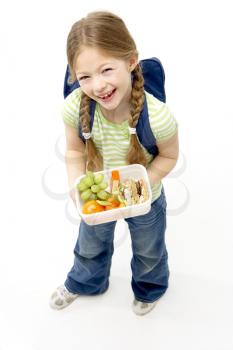Royalty Free Photo of a Little Girl With a Backpack Holding Lunch