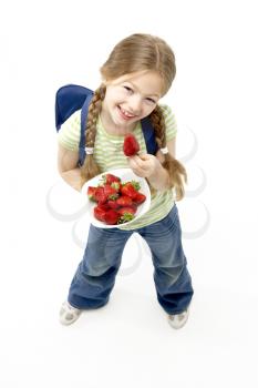 Studio Portrait of Smiling Girl Holding Bowl of Strawberries