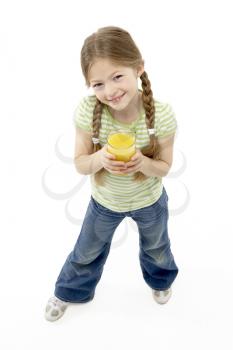 Studio Portrait of Smiling Girl Holding Orange Juice