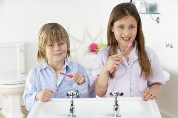 Royalty Free Photo of Siblings Brushing Their Teeth