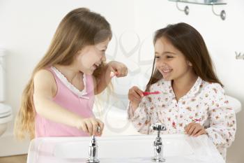 Royalty Free Photo of Two Little Girls Brushing Their Teeth