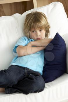 Royalty Free Photo of a Little Boy on a Sofa at Home