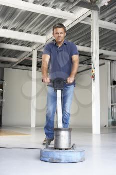 Royalty Free Photo of a Man Cleaning the Floor