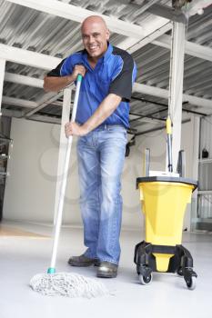 Royalty Free Photo of a Cleaner Mopping a Floor