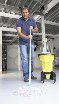 Royalty Free Photo of Man Mopping