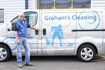 Royalty Free Photo of a Cleaner Next to a Van