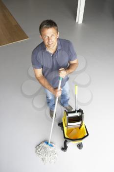 Royalty Free Photo of a Cleaner Mopping a Floor
