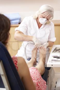 Royalty Free Photo of a Chiropodist With a Client