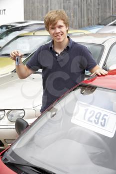 Royalty Free Photo of a Young Man Collecting a New Car