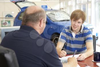 Royalty Free Photo of a Young Man Buying a Car