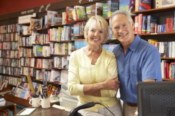Royalty Free Photo of a Couple Running a Bookshop