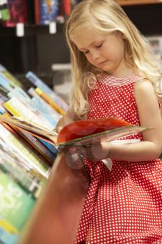Royalty Free Photo of a Little Girl in a Bookshop