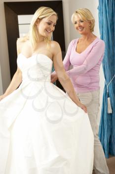 Royalty Free Photo of a Bride Trying on a Bridal Gown