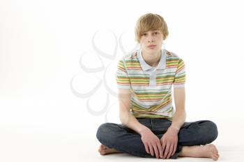 Royalty Free Photo of a Boy Sitting on the Floor