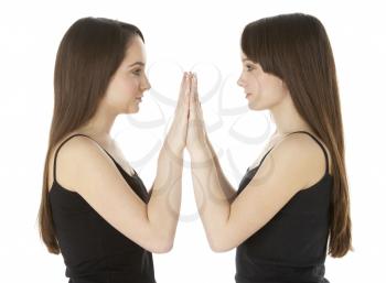 Royalty Free Photo of Twin Sisters Facing Each Other
