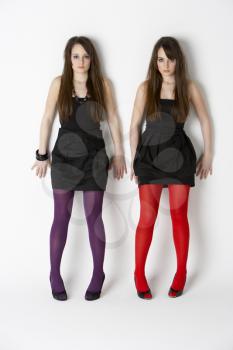 Royalty Free Photo of Two Girls in Coloured Tights and Black Dresses