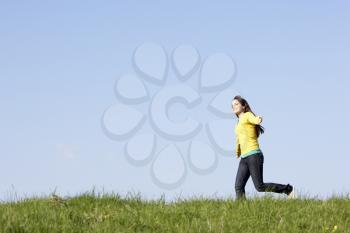 Royalty Free Photo of a Woman Running in a Field