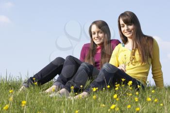 Royalty Free Photo of Girls in a Field of Buttercups