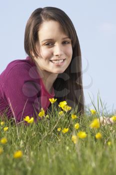 Royalty Free Photo of a Girl Lying in Buttercups