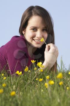 Royalty Free Photo of a Girl Lying in a Field of Buttercups