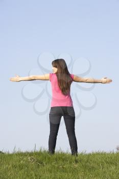 Royalty Free Photo of a Girl Standing With Her Arms Open