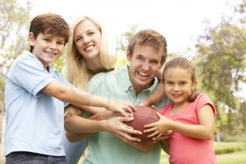 Royalty Free Photo of a Family With a Football