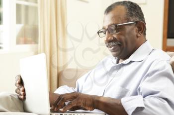 Royalty Free Photo of a Man at Home With a Laptop