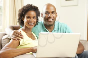 Royalty Free Photo of a Couple at Home With a Laptop