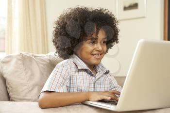 Royalty Free Photo of a Little Boy With a Laptop