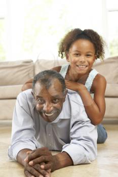 Royalty Free Photo of a Grandfather and Granddaughter at Home
