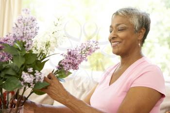 Royalty Free Photo of a Woman Arranging Flowers