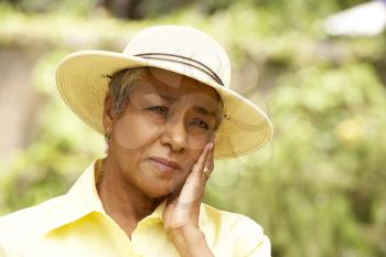 Royalty Free Photo of a Worried Woman in a Straw Hat