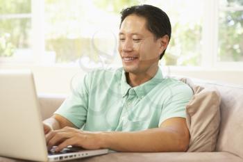 Royalty Free Photo of a Man at Home With a Computer