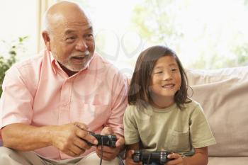 Royalty Free Photo of a Grandfather and Grandson Playing Video Games