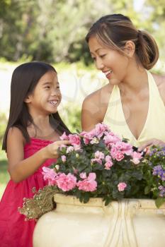 Royalty Free Photo of a Mother and Daughter With Flowers