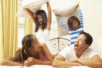 Royalty Free Photo of a Family Having a Pillow Fight