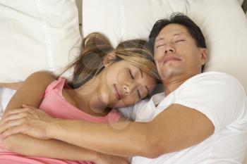 Royalty Free Photo of an Asian Couple in Bed
