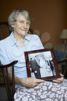 Royalty Free Photo of a Woman Holding an Old Wedding Picture