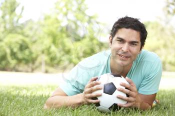 Royalty Free Photo of a Guy on the Ground With a Soccer Ball