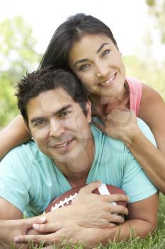 Royalty Free Photo of a Young Couple With a Football
