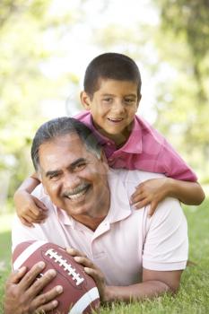 Royalty Free Photo of a Grandfather and Grandson With a Football