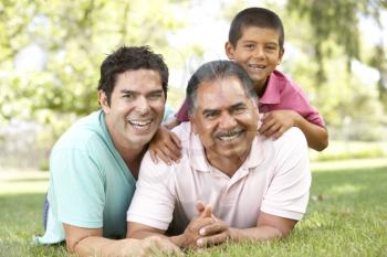 Royalty Free Photo of Three Generations of Men on the Grass