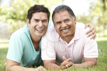 Royalty Free Photo of a Father and Son on the Grass