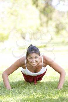 Royalty Free Photo of a Girl Doing Pushups Outside
