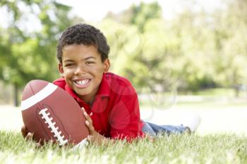 Boy In Park With American Football
