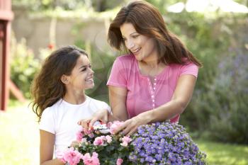 Mother And Daughter Gardening Together