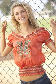 Royalty Free Clipart Image of a Girl Standing at a Ball Fence