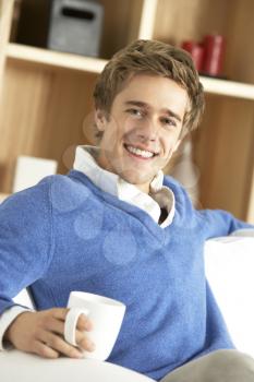 Young Man Relaxing With Cup Of Coffee